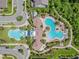 Aerial view showcasing multiple community pools, a splash pad, clubhouse, and meticulously landscaped common areas at 1796 Tonka Ter, Wesley Chapel, FL 33543