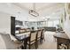 Open concept dining room with elegant seating, connected to a cozy living room and modern kitchen at 1796 Tonka Ter, Wesley Chapel, FL 33543
