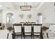 An elegant dining room features a rectangular table with upholstered chairs and modern lighting at 1796 Tonka Ter, Wesley Chapel, FL 33543