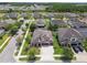 Front aerial view of a two story house with a two car garage, stone accents, and well maintained lawn at 1796 Tonka Ter, Wesley Chapel, FL 33543