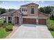 Stunning two-story home with stone accents, well-manicured landscaping, and a three-car garage at 1796 Tonka Ter, Wesley Chapel, FL 33543