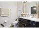 Traditional half bath featuring a dark vanity, white marble counter and framed mirror at 1796 Tonka Ter, Wesley Chapel, FL 33543