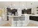 Spacious kitchen with dark cabinets, stainless steel appliances, and a cozy breakfast bar at 1796 Tonka Ter, Wesley Chapel, FL 33543
