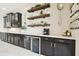 Kitchen featuring under counter refrigerators, dark cabinetry, decor shelves, and quartz countertops at 1796 Tonka Ter, Wesley Chapel, FL 33543