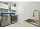 Well-equipped laundry room with modern stainless steel washer and dryer at 1796 Tonka Ter, Wesley Chapel, FL 33543