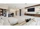 Spacious living room featuring a large couch, TV, and workstation at 1796 Tonka Ter, Wesley Chapel, FL 33543