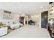 Open living room featuring light carpet, large couch, desk and shelves at 1796 Tonka Ter, Wesley Chapel, FL 33543