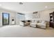 Spacious living room featuring a sectional sofa, a window, and a door to the outside at 1796 Tonka Ter, Wesley Chapel, FL 33543