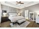 Serene main bedroom boasts a tray ceiling, plush carpeting, and a luxurious ensuite bathroom at 1796 Tonka Ter, Wesley Chapel, FL 33543
