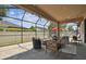 Screened patio featuring ample seating arrangements, string lights, and a comfortable spot for outdoor relaxation at 1796 Tonka Ter, Wesley Chapel, FL 33543