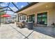 Spacious screened patio offering various seating arrangements and comfortable entertaining areas at 1796 Tonka Ter, Wesley Chapel, FL 33543