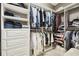 Organized walk-in closet with ample shelving, drawers, and hanging space for clothing and accessories at 1796 Tonka Ter, Wesley Chapel, FL 33543