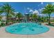 Community splash pad features water fountains, tropical palm trees, and a central tower for Gathering fun at 1796 Tonka Ter, Wesley Chapel, FL 33543