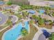 Aerial shot of a community splash pad featuring water fountains and a nearby community pool with palm trees at 1796 Tonka Ter, Wesley Chapel, FL 33543