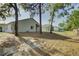 Backyard view of a home with a screened-in patio surrounded by mature trees at 18918 Emerald Ridge Dr, Hudson, FL 34667