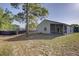 View of the back of a home with a screened-in patio and spacious grassy yard at 18918 Emerald Ridge Dr, Hudson, FL 34667