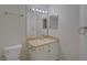 Neutral bathroom with a single sink vanity, toilet, and basic fixtures at 18918 Emerald Ridge Dr, Hudson, FL 34667