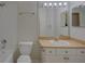 Neutral bathroom with a single sink vanity, toilet, and shower-tub combination at 18918 Emerald Ridge Dr, Hudson, FL 34667