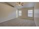 Carpeted bedroom featuring neutral colors and two large windows at 18918 Emerald Ridge Dr, Hudson, FL 34667