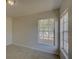 Bedroom with neutral carpet and two windows with blinds at 18918 Emerald Ridge Dr, Hudson, FL 34667