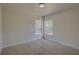 Bedroom featuring neutral carpet and view of two windows with blinds at 18918 Emerald Ridge Dr, Hudson, FL 34667