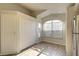Bright breakfast nook with tile floors, closet, and a large arched window letting in natural light at 18918 Emerald Ridge Dr, Hudson, FL 34667