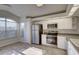 Well-lit kitchen with stainless steel appliances and a tiled floor at 18918 Emerald Ridge Dr, Hudson, FL 34667