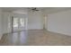 Neutral living room featuring a ceiling fan and access to a private back yard at 18918 Emerald Ridge Dr, Hudson, FL 34667