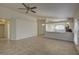 Open-concept living room with tiled floors and an view into the kitchen at 18918 Emerald Ridge Dr, Hudson, FL 34667