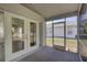 View of a screened patio connecting to an indoor space through glass doors at 18918 Emerald Ridge Dr, Hudson, FL 34667