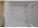 White tiled shower-tub combination with updated fixtures at 18918 Emerald Ridge Dr, Hudson, FL 34667