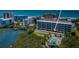 Aerial view of condo building with community pool, lush landscaping, and waterfront location at 19519 Gulf Blvd # 203, Indian Shores, FL 33785