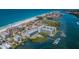 Beautiful aerial view of waterfront property with beach access, boat docks and lush greenery at 19519 Gulf Blvd # 203, Indian Shores, FL 33785