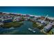 Aerial shot of beach neighborhood highlighting waterfront condos, coastline, and boat docks at 19519 Gulf Blvd # 203, Indian Shores, FL 33785