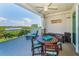 Relaxing outdoor patio with lounge chair and table seating area, with water view at 19519 Gulf Blvd # 203, Indian Shores, FL 33785