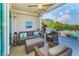 Spacious balcony with wicker furniture and views of a swimming pool and palm trees at 19519 Gulf Blvd # 203, Indian Shores, FL 33785