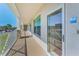 Exterior balcony with tan floors, white railings, and glass doors offering a relaxing outdoor space at 19519 Gulf Blvd # 203, Indian Shores, FL 33785