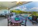 Spacious covered balcony with comfortable seating and views of the community pool and bay at 19519 Gulf Blvd # 203, Indian Shores, FL 33785