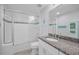 Well-lit bathroom with single vanity, granite countertops, and shower-tub combination at 19519 Gulf Blvd # 203, Indian Shores, FL 33785