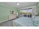 Bedroom boasting balcony, white furniture, modern ceiling fan, area rug, and light green walls at 19519 Gulf Blvd # 203, Indian Shores, FL 33785