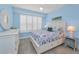 Coastal bedroom featuring wood-look floors, white shutters, and nautical-themed bedding at 19519 Gulf Blvd # 203, Indian Shores, FL 33785