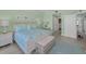 Relaxing bedroom features a comfortable queen bed, stylish furniture, and access to hallway at 19519 Gulf Blvd # 203, Indian Shores, FL 33785