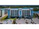 Exterior view of modern condo building featuring multiple floors and parking area at 19519 Gulf Blvd # 203, Indian Shores, FL 33785