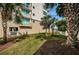 A view of the exterior of the building featuring a landscaped lawn at 19519 Gulf Blvd # 203, Indian Shores, FL 33785