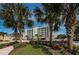 Exterior of the property featuring meticulous landscaping and ample parking at 19519 Gulf Blvd # 203, Indian Shores, FL 33785
