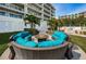 Inviting courtyard area with comfortable seating and a charming fire pit at 19519 Gulf Blvd # 203, Indian Shores, FL 33785