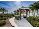 Charming gazebo with pathway, offering a tranquil retreat surrounded by lush landscaping, enhancing outdoor enjoyment at 19519 Gulf Blvd # 203, Indian Shores, FL 33785