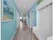 Light blue hallway featuring modern lighting, doors to the different rooms, and beach-inspired decor at 19519 Gulf Blvd # 203, Indian Shores, FL 33785