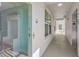 Bright hallway with elevator access and natural light showcasing the well-maintained property at 19519 Gulf Blvd # 203, Indian Shores, FL 33785