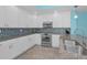 Well-equipped kitchen featuring stainless steel appliances and stylish backsplash at 19519 Gulf Blvd # 203, Indian Shores, FL 33785